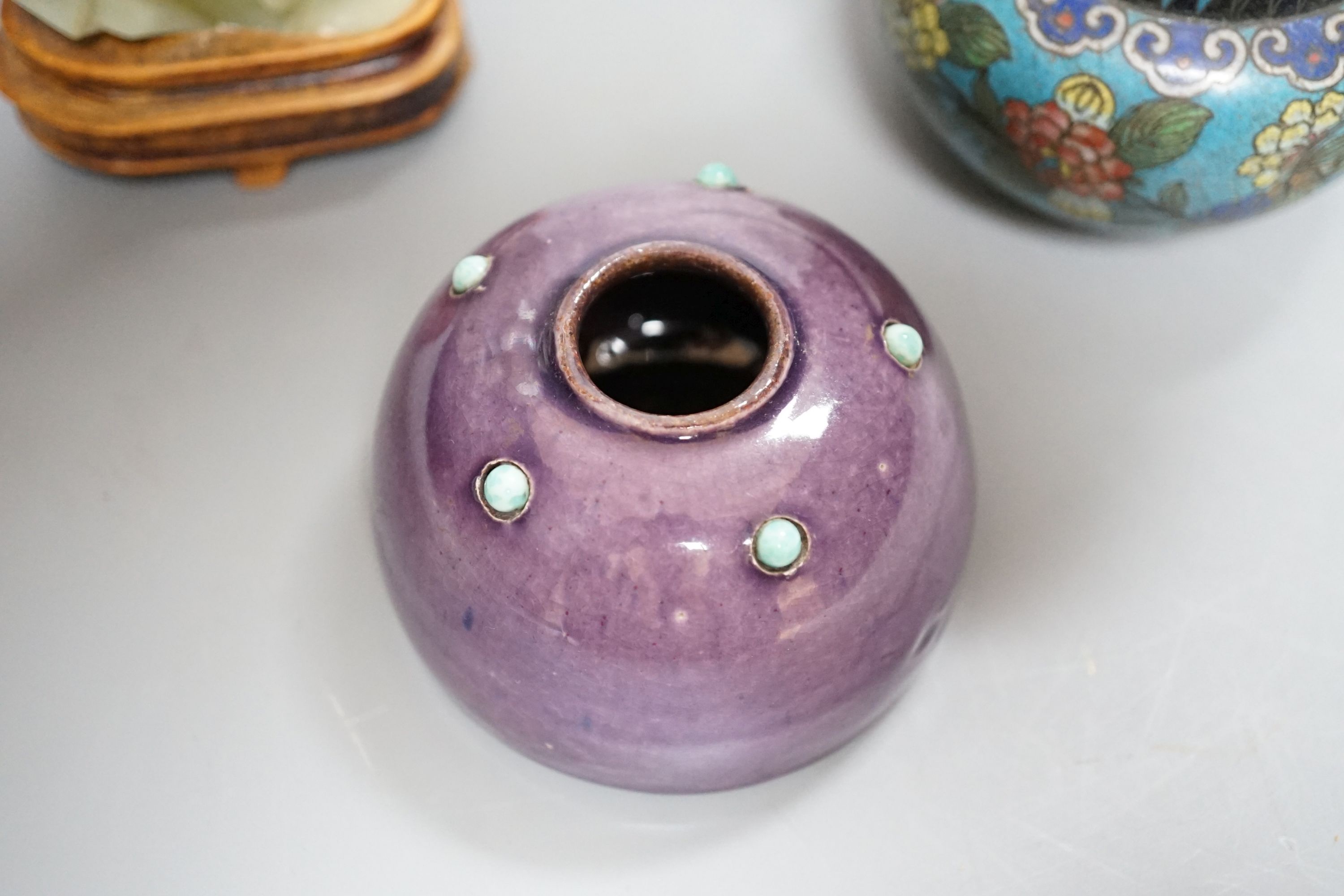 A small enamelled cloisonné vase, 10cm, together with a carved bowenite jade figure, on wood plinth and glazed ceramic brush pot